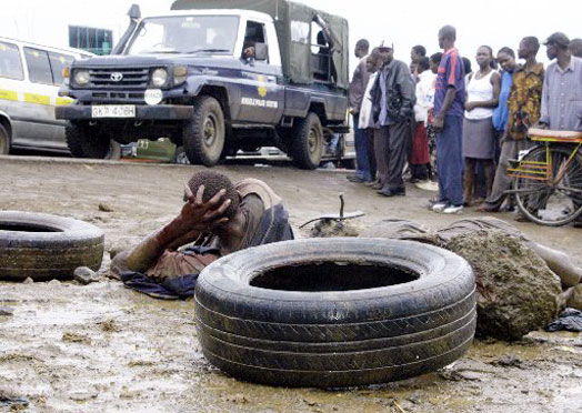 Two robbery suspects lie on the ground during a past incident of mob injustice. PHOTO | JACOB OWITI