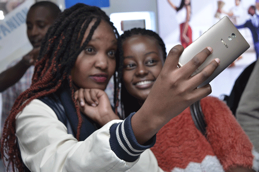 Customers take a selfie with a Tecno Camon 9 phone during its launch in Nairobi. PHOTO | HILARY KIMUYU