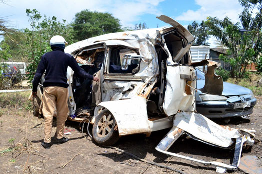 A police officer at Mawe Mbili Police Post inspects the wreckage of a vehicle that was involved in a road accident along the Eastern bypass, Ruai that claimed the lives of six family members PHOTO | FRANCIS NDERITU