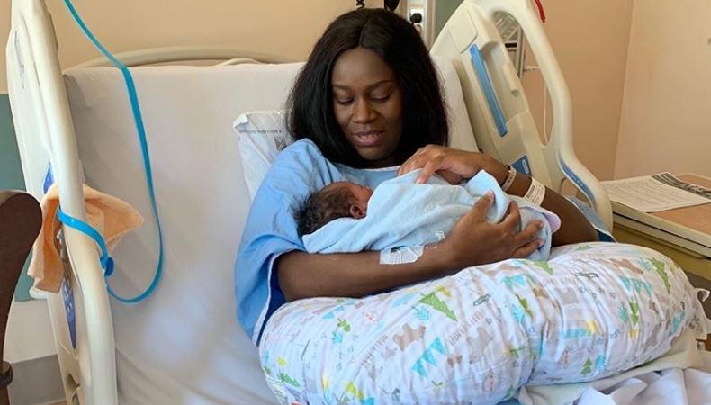 Ugandan singer Juliana Kanyomozi holds her bundle of joy in a hospital bed. PHOTO | COURTESY